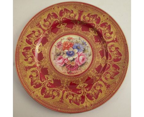 A Royal Worcester cabinet plate, decorated with flowers to the centre by Freeman, with burgundy and gilt border, diameter 10.