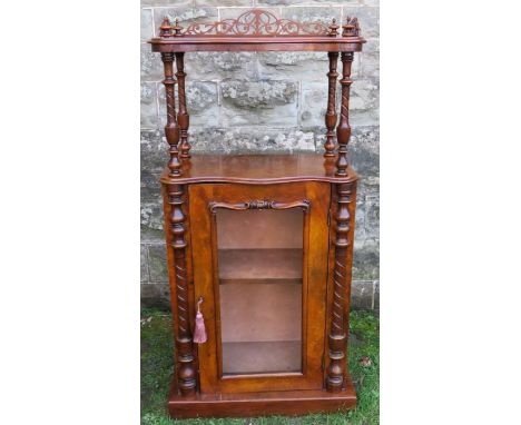 A Victorian walnut cabinet, with shelf having pierced gallery to three sides, raised on turned columns over a glazed front ca