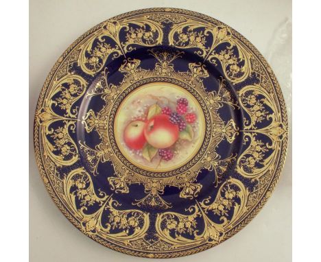 A Royal Worcester plate, decorated with a hand painted fruit centre by S Weston, to a rich blue and gilt border, diameter 10.