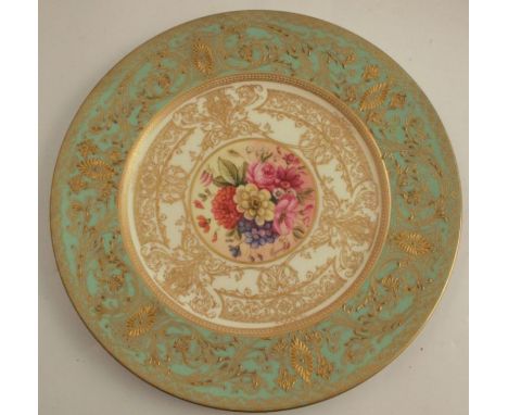 A Royal Worcester cabinet plate, decorated with flowers to the centre by Higgins, with green and gilt border, diameter 10.5in