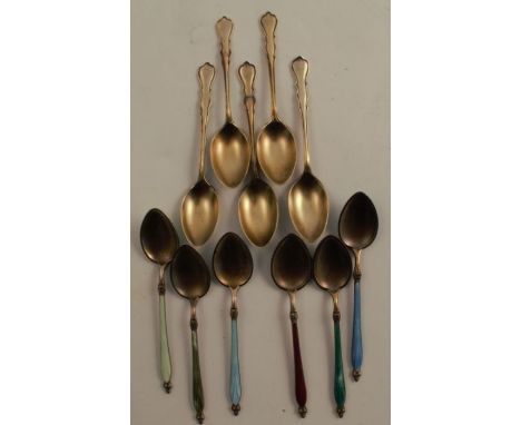 A set of six silver gilt and enamel coffee spoons, together with a set of silver gilt coffee spoons