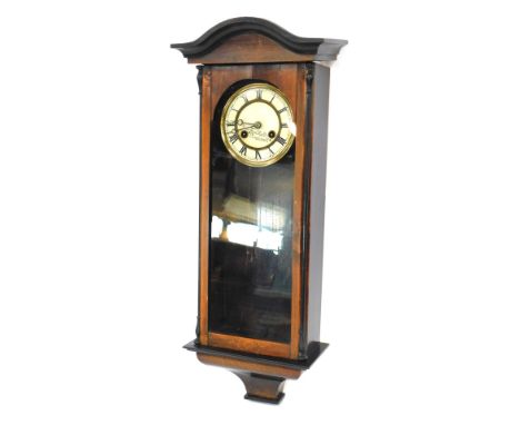 A Fred Hall of Pinchbeck mahogany cased wall clock, with cream Roman numeric dial, ebonised outer moulded border, and glazed 