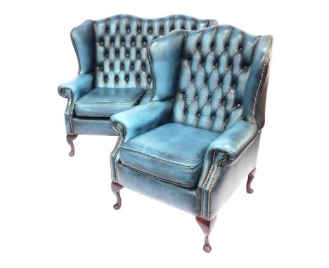 A Saxon button back wingback two seater sofa, with stud work, raised on four cabriole legs, with pad feet, 130cm wide, togeth