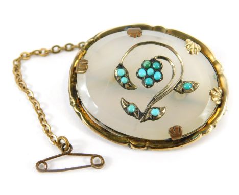 An Edwardian pendant, of oval design with a petallated and shell capped outer border, pinchbeck outer frame, with central tur