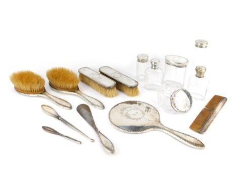 A George VI silver mounted harlequin dressing table set, comprising hand mirror, two hair brushes, two clothes brushes, comb,