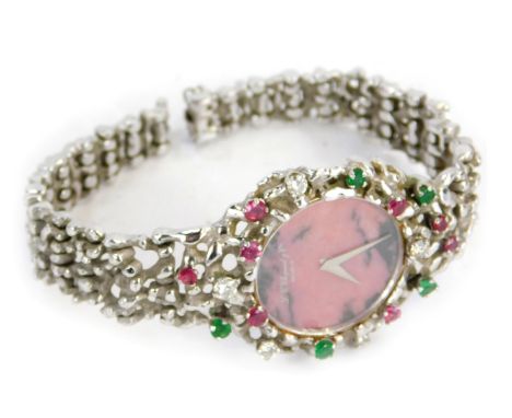 A L-u Chopard and Co lady's wristwatch, with bark effect design strap and outer casing, set with rubies, emeralds, and diamon