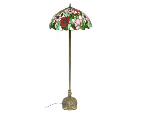 A Tiffany style standard lamp, the domed cream shade with pink and red flowers and green leaves, on a gold finish chrome stan