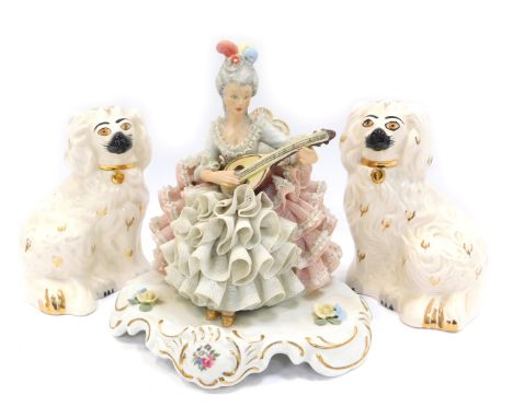 A 20thC Dresden porcelain crinoline figure, modelled as a lady seated playing musical instrument, 19cm high, together with tw