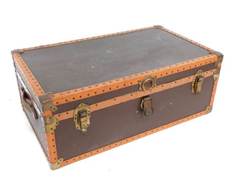 An early 20thC brown and tan leather bound trunk, with brass fittings, named to the lid for M. Dobney Gosberton Risegate, Nr 