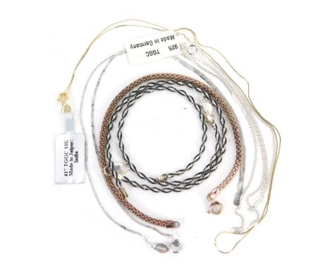 Five pendants and bracelets, comprising two black and silver finish twist design bracelets, white metal stamped 925, a yellow