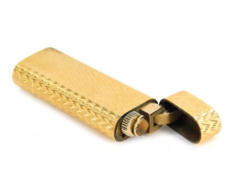 A Must De Cartier gold plated lighter, with engine engraved decoration, serial number 144132, 7cm high. 