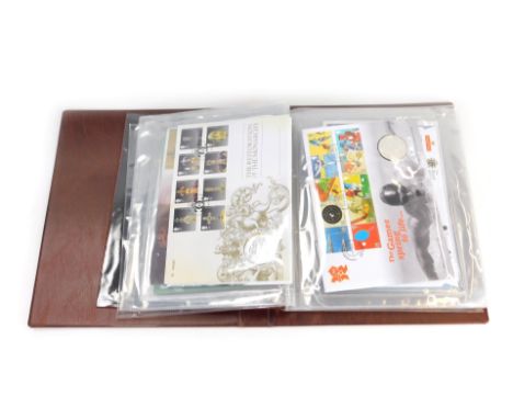 Four Royal Mail albums, comprising two The Classic Numismatic Covers coin  albums, another album containing coin covers, and 