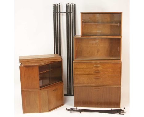 A 1970s Avalon teak modular wall unit, comprising; two corner sections, one with twin glass sliding doors, the other with pan