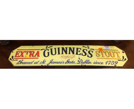 An enamel on metal advertising sign for Guinness Extra Stout, 12.5 x 57cm