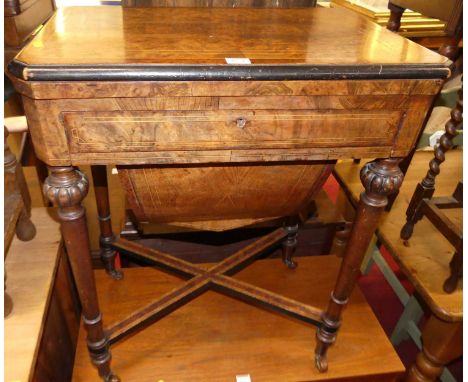 A mid-Victorian figured walnut, ebonised, and satinwood strung fold-over games table, having a baize lined interior, single f