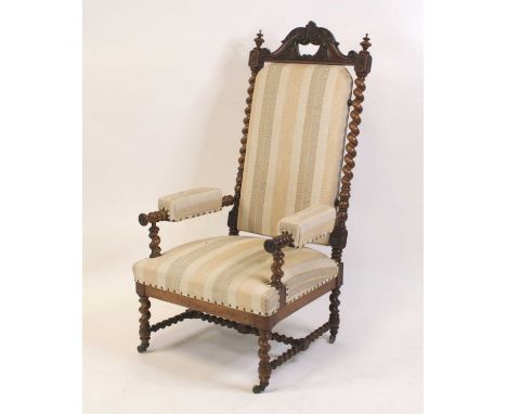 A Victorian rosewood framed and upholstered armchair, having acanthus leaf carved and swept toprail, on spiral turned columns