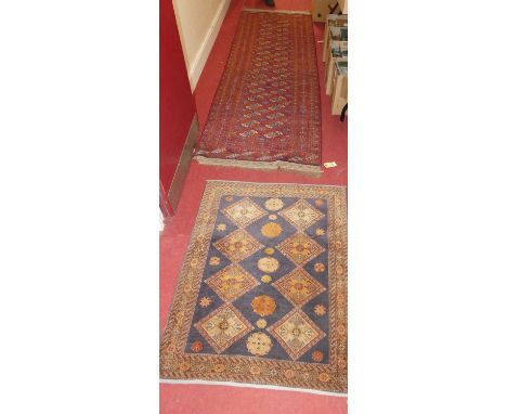 A Persian woollen red ground Bokhara hall runner, having flatweave Kelim ends, 276 x 84cm; together with a small Persian blue