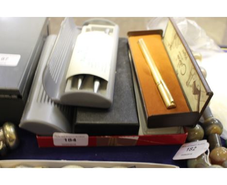 A box containing Parker and other pens; and a Colibri lighter