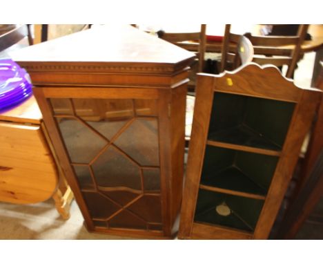 A glazed corner cupboard; and an open corner shelf 