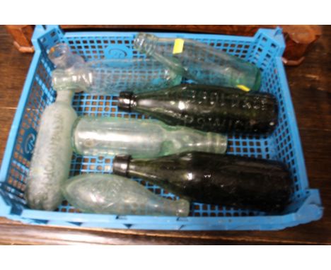A box of vintage glass bottles, some relating to Ipswich and Cobbold &amp; Co.