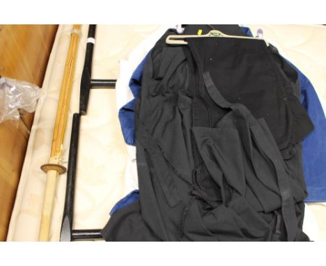 A Kindo stick; two batons; and a collection of martial arts and jujitsu clothing