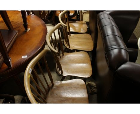 A set of four Ercol stick back dining chairs 