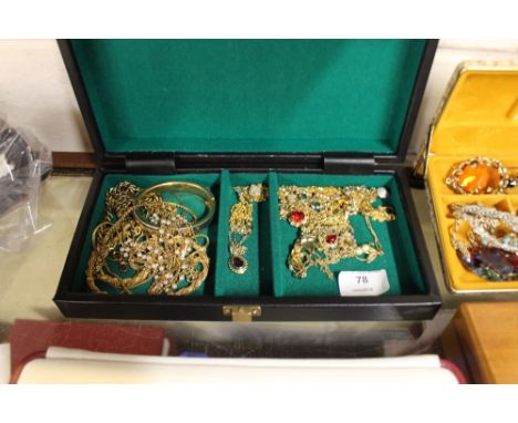 A jewellery box and contents of various yellow metal pendants, bangle etc. 