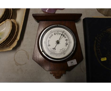 An Art Deco oak cased barometer 