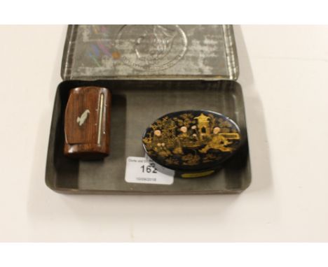 A South Africa 1900 "Gift To The Troops" tin; an oval papier maché chinoiserie decorated snuff box; and a wooden and white me