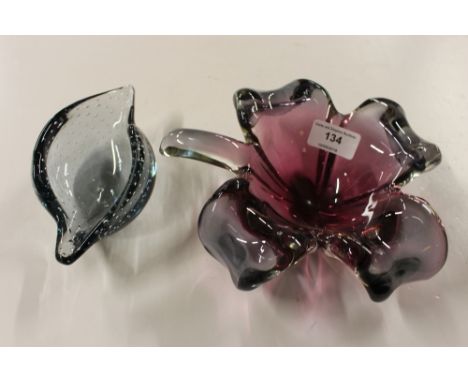 A heavy ruby glass leaf shaped dish; and a smaller blue tinted glass example 