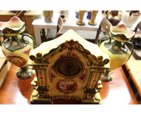 A pottery mantel clock and pair of vases 