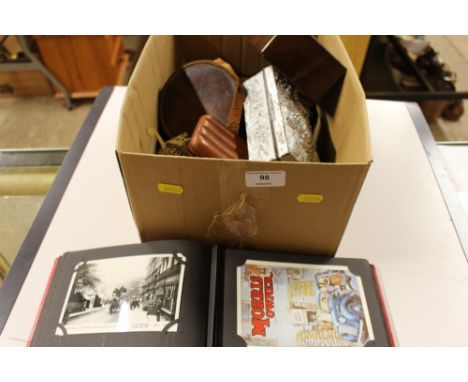 A box containing an album of post-cards; chess pieces; oriental metal trinket box; a cash tin; a leather cheroot case etc. 