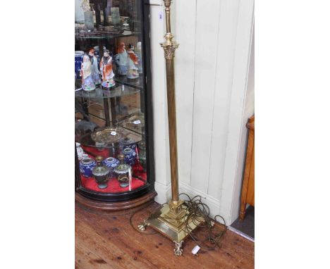 Telescopic brass corinthian column standard lamp on claw feet.