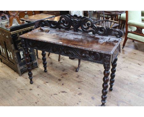 Victorian carved oak side table having a drawer to one end and raised on bobbin legs, 122cm by 77cm.