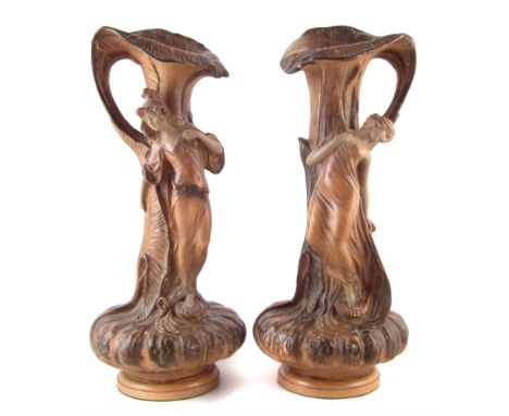 Pair of Painted plaster Art Nouveau ewers, moulded as gourds with leafwork spouts and handles, each with a maiden standing to