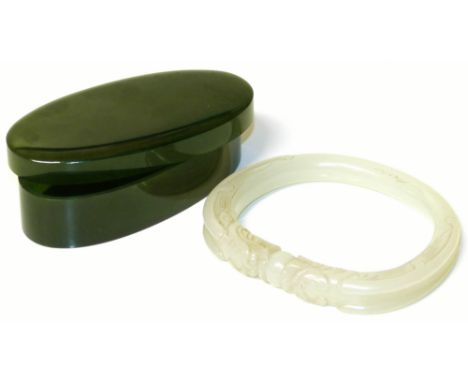 Jadeite bangle and a green stone box Condition reports are not available for the Interiors Sale.