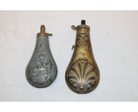 A 19th century brass powder flask with raised decoration and a 19th century zinc powder flask with brass top (2)