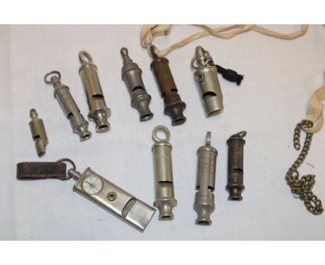 A collection of 10 various old whistles including nickel plated military whistle with inset compass, the Boy Scout patent whi