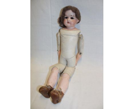 An old German porcelain headed doll marked "Cbr. 140 K" with leather body and porcelain lower limbs, 18" long