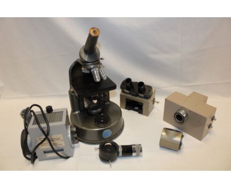 A monocular microscope by C Baker of London (requiring attention) and a selection of various optical parts mainly microscope 