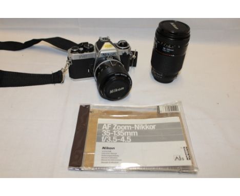 A Nikon FE2 35mm studio camera with 35-135mm telephoto lens and accessories