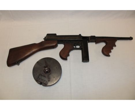 A good quality replica of an American Thompson machine gun model 1921 with stick and drum magazines