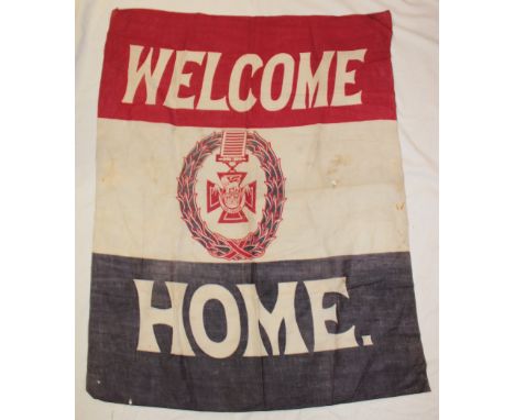 A First War cotton "Welcome Home" banner with central Victoria Cross emblem, 42" x 33"