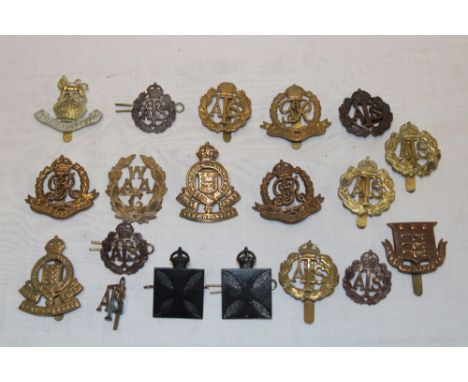 A selection of various military cap badges including two Army Chaplain's Department badges, ATS, WAAC, Royal Military Police,