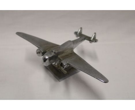 A chromium-plated desk model of a twin engine aircraft