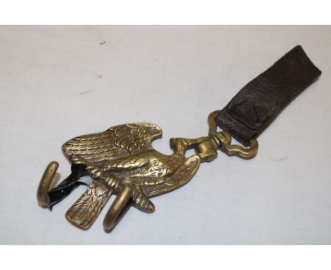 A First War/Second War German brass drum hanger with eagle decoration and leather belt loop