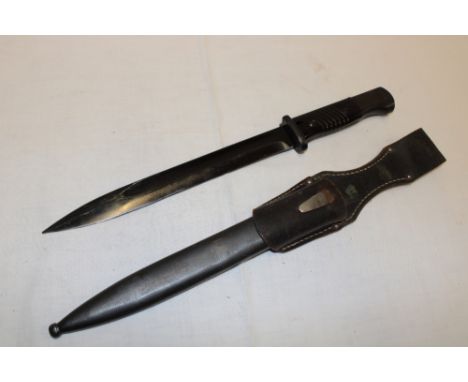 A German K98 Mauser bayonet with 10" blackened steel blade marked "44 fnj" in steel scabbard with leather frog