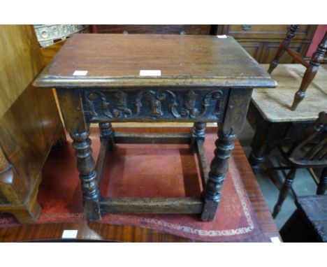 A 17th Century style carved oak stool 