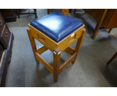 A 1930's Art Deco carved oak counter stool 