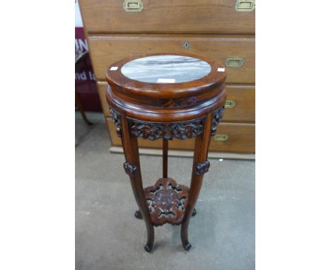 A Chinese carved hardwood and marble topped jardiniere stand, 82cms h, 32cms dia. 